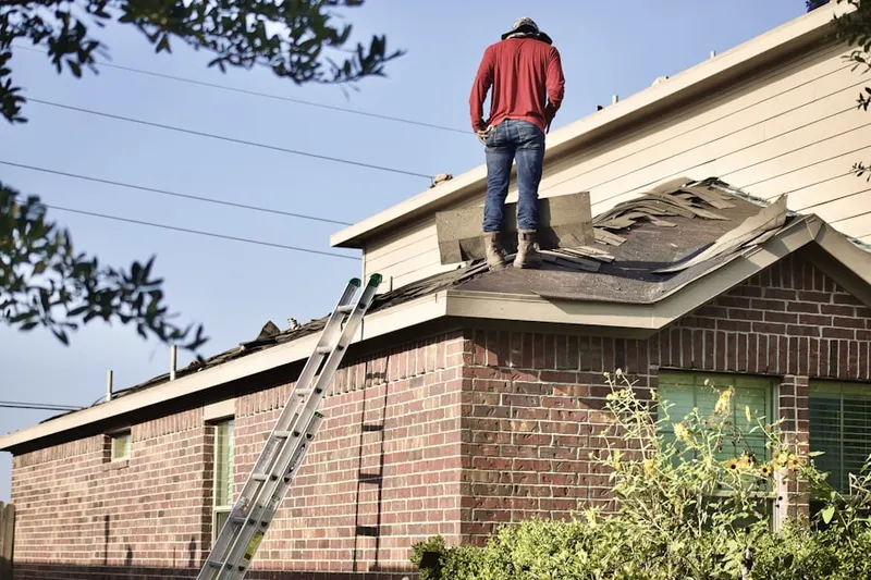 Professional roofer working on a residential roof in Hayes